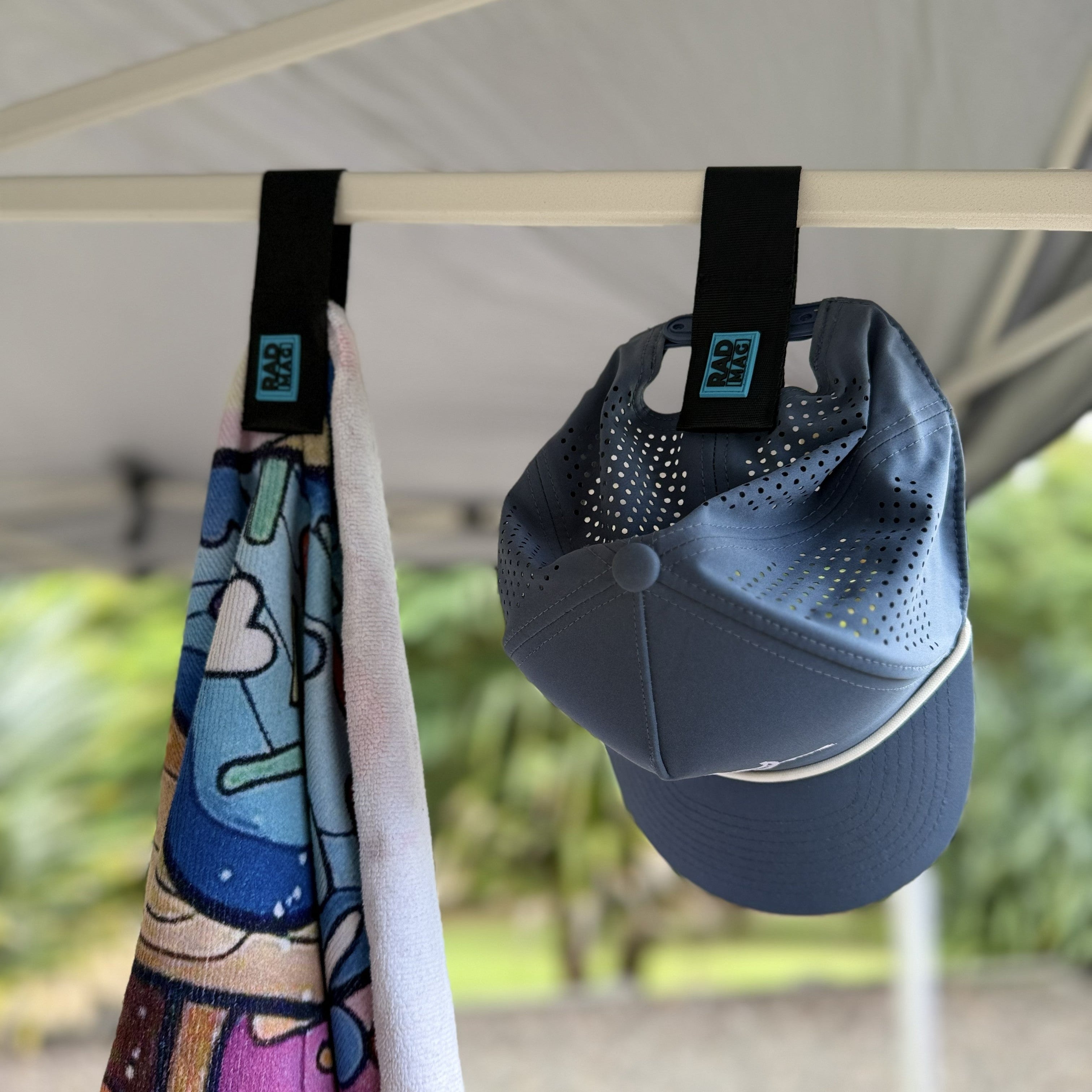 Towel and blue cap hanging by the magnetic Rad Mag strap.